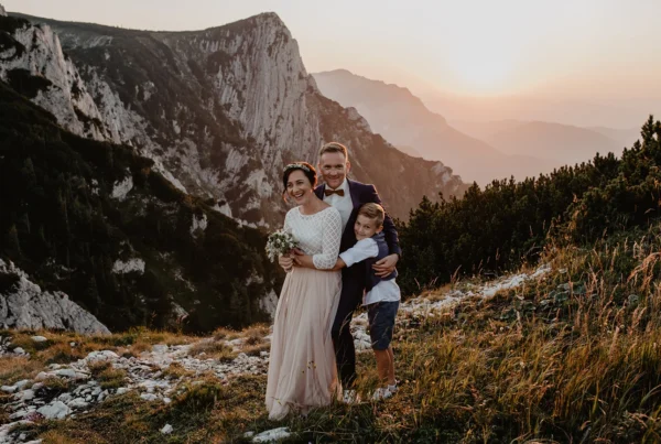 Familienfoto bei Sonnenuntergang am Feuerkogel mit Blick auf den Alberfeldkogel im Salzkammergut, fotografiert bei einer Berg-Hochzeit am Feuerkogel von Hochzeitsfotograf Nicole Salfinger